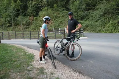 a man and a woman standing next to a bike at Guesthouse Silvani in Kruševac
