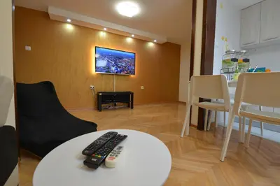 a living room with two remote controls on a table at Paradise in Vrnjačka Banja