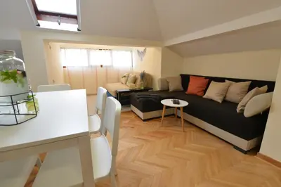 a living room with a couch and a table at Paradise in Vrnjačka Banja