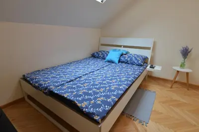 a bedroom with a bed with blue pillows on it at Paradise in Vrnjačka Banja