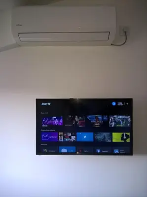 a tv hanging on a wall with a screen at Apartmani Mimi in Soko Banja