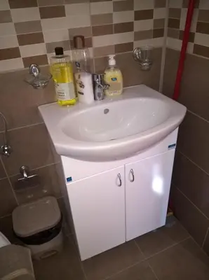 a bathroom with a white sink in a room at Apartmani Mimi in Soko Banja