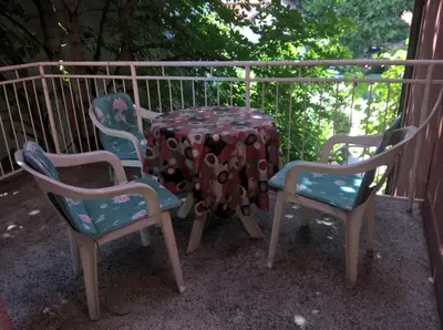 a table and four chairs sitting on a porch at Apartmani Mimi in Soko Banja
