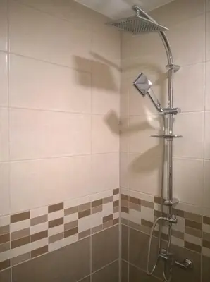 a shower with a shower head in a bathroom at Apartmani Mimi in Soko Banja