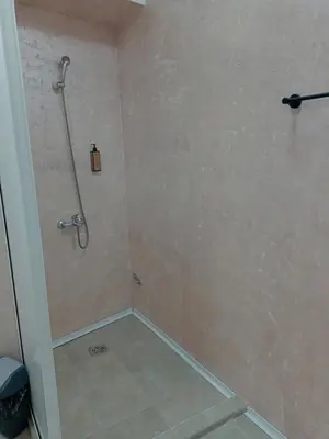 a shower stall in a bathroom with a tile floor at VILIN in Niš