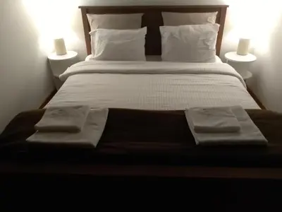 a bedroom with a bed with two towels on it at Sanjar in Vrnjačka Banja