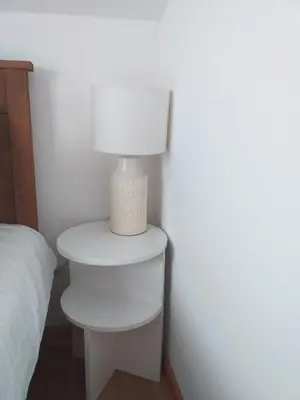 a white lamp on a table next to a bed at Sanjar in Vrnjačka Banja