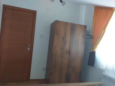 a room with a wooden cabinet next to a door at Sanjar in Vrnjačka Banja