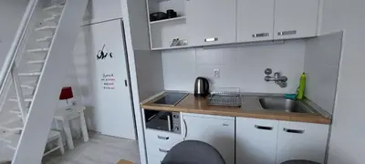 a small kitchen with a sink and a ladder at Uni Kop in Brzeće