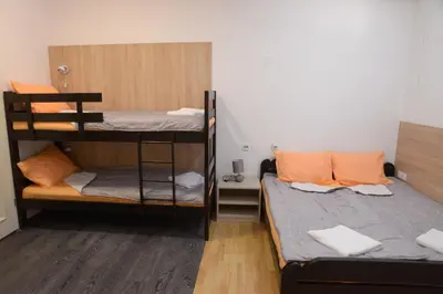 a room with two bunk beds in a room at Guest House GOLDEN COIN in Niš