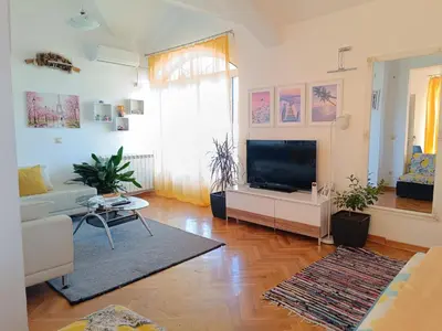 a living room with a flat screen tv and a couch at Vila Sentić in Vranje