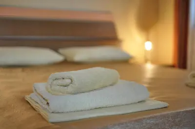 a pile of towels sitting on top of a wooden floor at Apartments Raj in Vrnjačka Banja