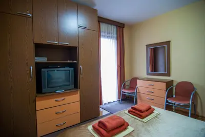 a hotel room with a tv and a bedroom at Apartments Raj in Vrnjačka Banja