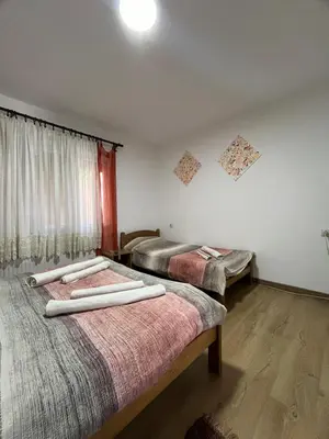 a room with two beds with towels on them at Vojin i Lena in Soko Banja