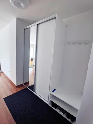 a sliding glass door in a room with a rug at Lux Studio Apartment Vidanovic in Pirot