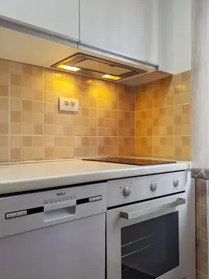 a kitchen with a stove and a white oven at Lux Studio Apartment Vidanovic in Pirot