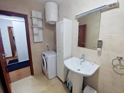 a bathroom with a sink and a toilet and a mirror at Lux Studio Apartment Vidanovic in Pirot