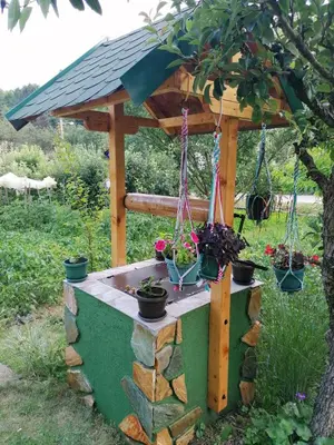 a wooden gazebo with potted plants on it at Kuca Mihajlovic in Svrljig