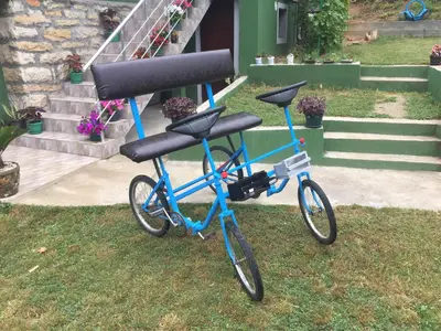 a bike parked in the grass in front of a house at Kuca Mihajlovic in Svrljig
