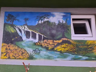 a painting of a waterfall on the side of a wall at Kuca Mihajlovic in Svrljig