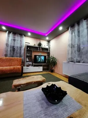 a living room with purple lights on the ceiling at Kuca Mihajlovic in Svrljig