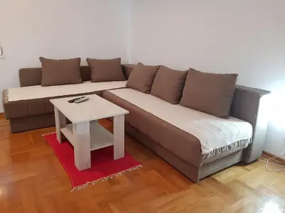 a living room with a couch and a table at Studio Dorna in Vrnjačka Banja
