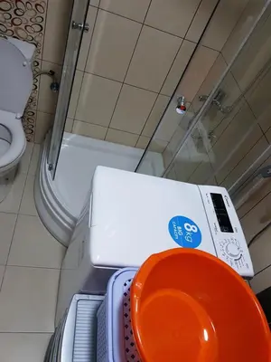 a bathroom with a toilet and an orange bowl at Studio Dorna in Vrnjačka Banja