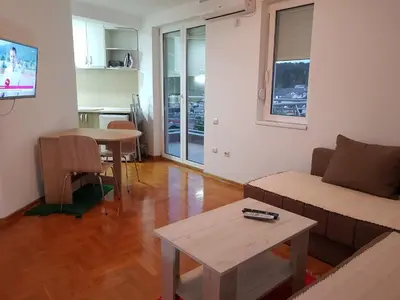 a living room with a couch and a table at Studio Dorna in Vrnjačka Banja
