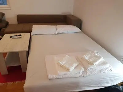 a bed with two pillows on it in a room at Studio Dorna in Vrnjačka Banja