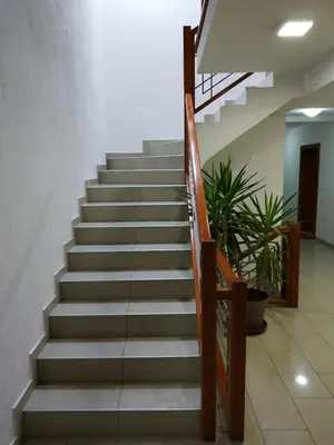 a set of stairs in a lobby with plants at Apartman ZENIT in Vrnjačka Banja