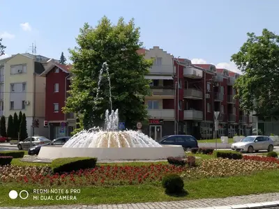 a fountain in the middle of a city at Apartman ZENIT in Vrnjačka Banja