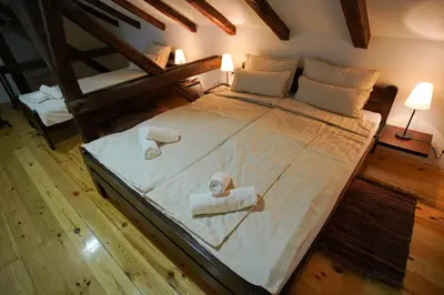 a bedroom with a large bed with towels on it at Epicenter in Niš