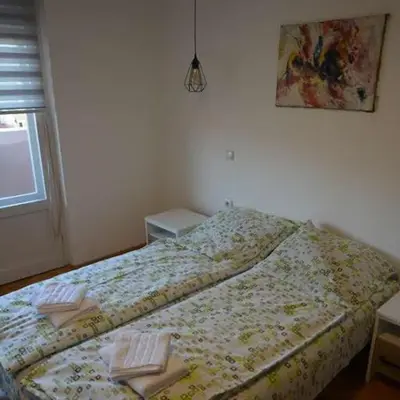a bedroom with a bed with two towels on it at VIV apartment 1 in Niš