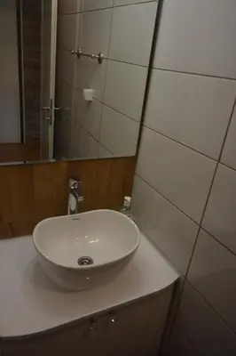 a bathroom with a white sink and a mirror at VIV apartment 1 in Niš