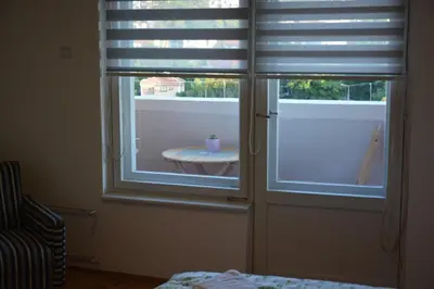 a room with two windows with blinds on them at VIV apartment 1 in Niš