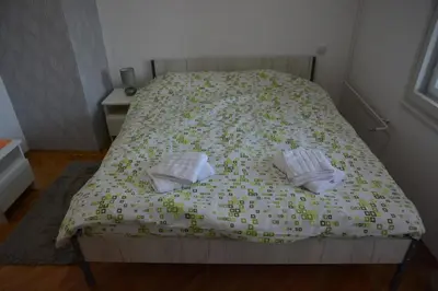 a bed with two pillows on it in a bedroom at VIV apartment 2 in Niš