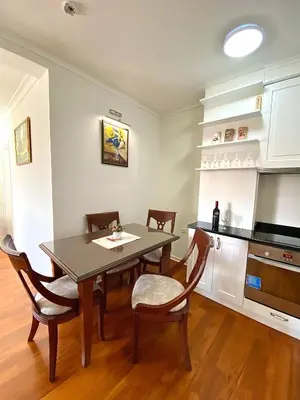 a kitchen with a dining room table and chairs at Lux Apartman 'Opereta' A-19 in Vrnjačka Banja