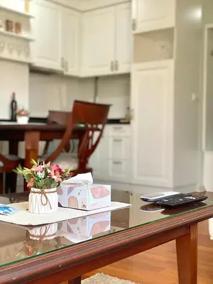 a table with flowers and boxes on it in a kitchen at Lux Apartman 'Opereta' A-19 in Vrnjačka Banja