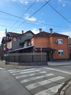 an empty street with a building and a crosswalk at Apartments Day Off in Aleksinac