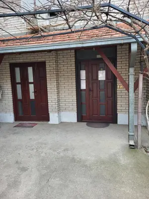 two entrances to a building with red doors at Apartments Day Off in Aleksinac