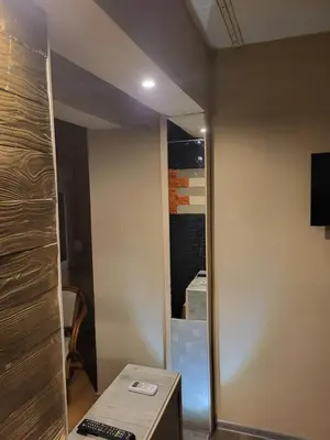 a living room with a mirror and a table at Apartments Day Off in Aleksinac