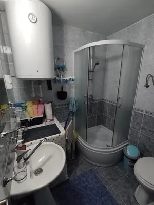 a bathroom with a shower and a sink and a toilet at Apartman “MEGI” in Soko Banja