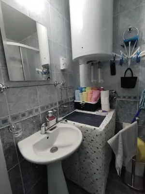 a bathroom with a sink and a mirror at Apartman “MEGI” in Soko Banja