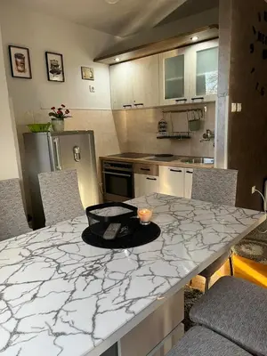 a kitchen with a table with a bowl on it at Apartman “MEGI” in Soko Banja