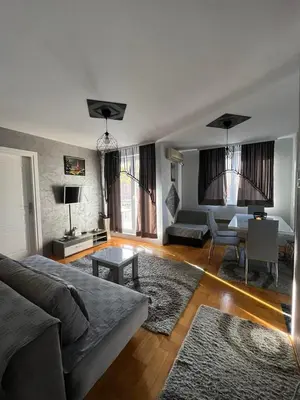 a living room with a couch and a table at Apartman “MEGI” in Soko Banja