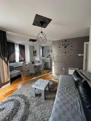 a living room with a couch and a table at Apartman “MEGI” in Soko Banja