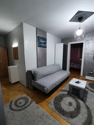 a living room with a couch and a table at Apartman “MEGI” in Soko Banja