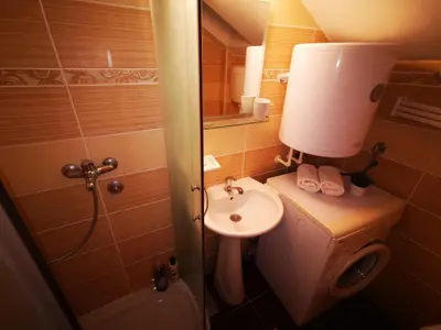 a small bathroom with a sink and a toilet at Sokobanja central park APT with mountain view balcony in Soko Banja