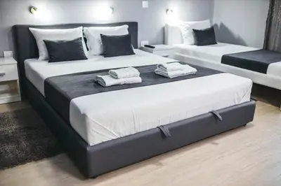 a bedroom with two beds with towels on them at King Exclusive Suites in Niš