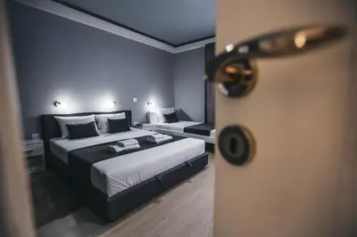 a hotel room with a bed and a door at King Exclusive Suites in Niš